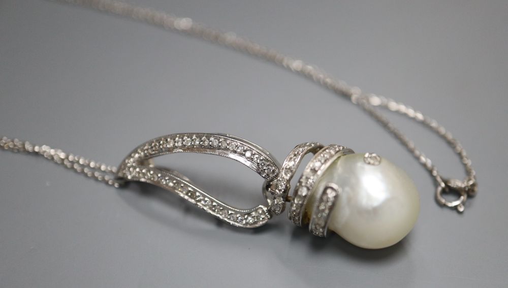 A modern 14k white metal, baroque pearl and diamond set drop pendant, on 750 white metal chain, pendant, 43mm, gross 8.5 grams.